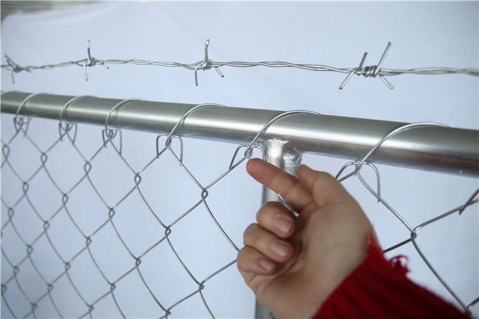 Barbed wire on the temporary chain link fence top side
